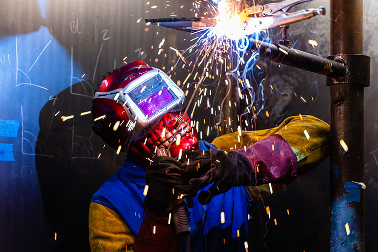 Welder welding a pipe